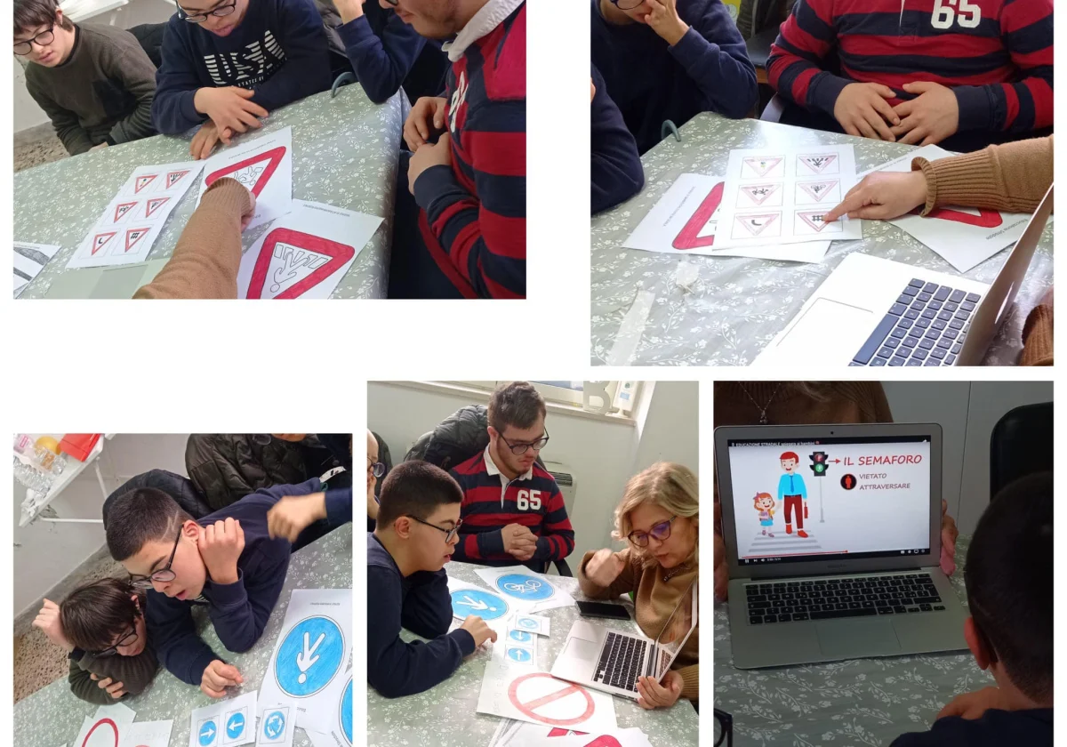 Un gruppo di ragazzi seduti a un tavolo, alle prese con schede sui segnali stradali disegnate a mano.