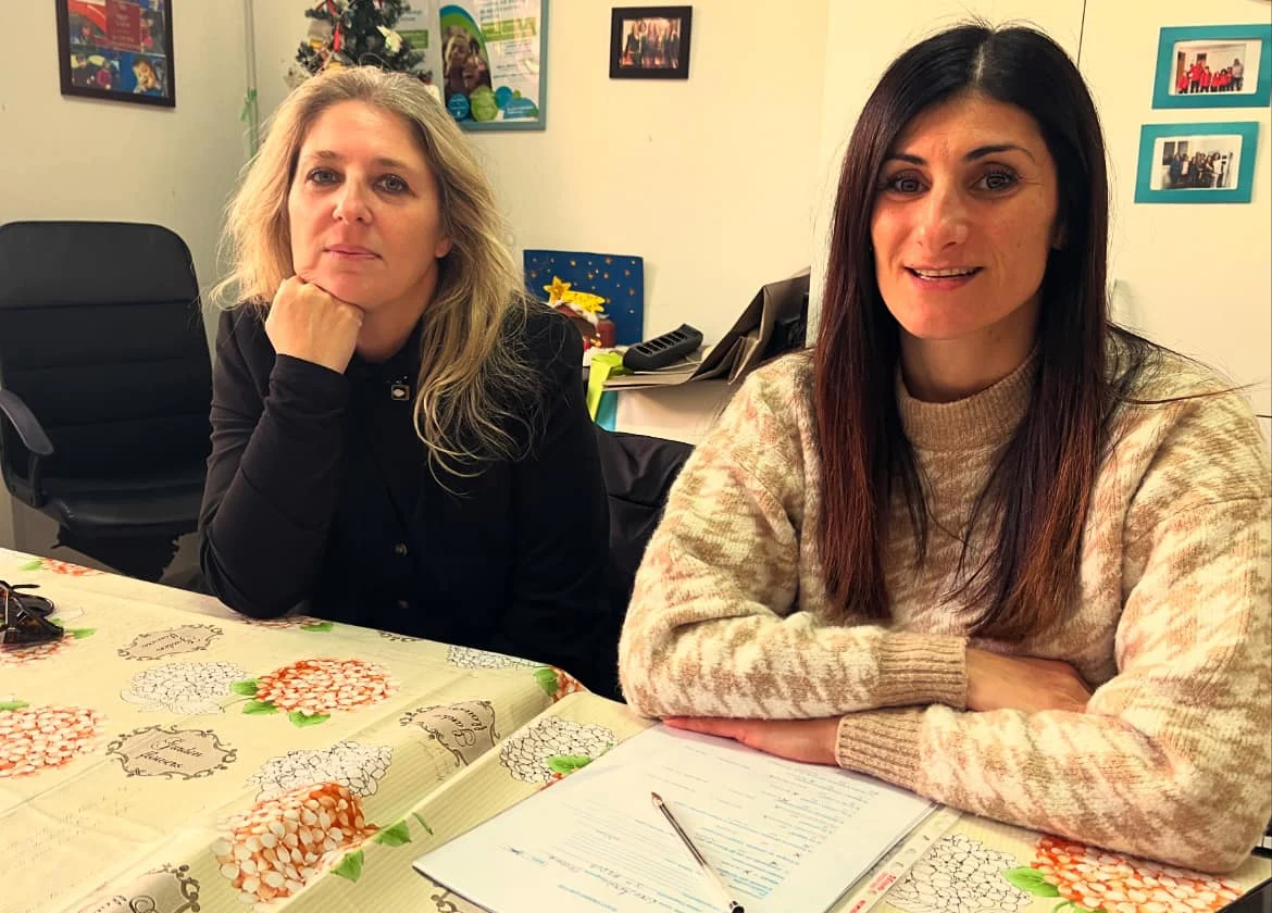 Due componenti dello staff dell'Associazione sedute a una scrivania in ufficio.